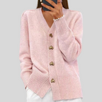 Pink cardigan sweater with V-neck, long sleeves, ribbed hem, heart-button front.