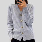Gray cardigan sweater with V-neck, long sleeves, ribbed cuffs, heart-button front.