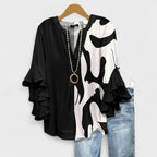 Women’s v-neck blouse with ruffle sleeves, black and white cow print with beaded trim