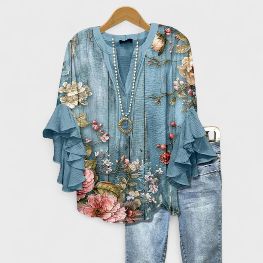 Women’s v-neck blouse with ruffle sleeves, dusty blue with colorful floral garden print