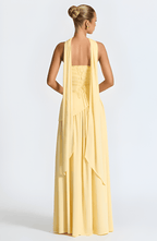 Strapless yellow maxi dress, back view with draped waist and cascading layered skirt