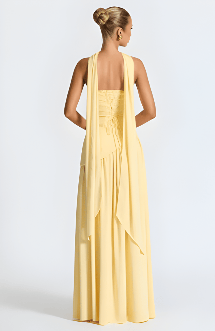 Strapless yellow maxi dress, back view with draped waist and cascading layered skirt