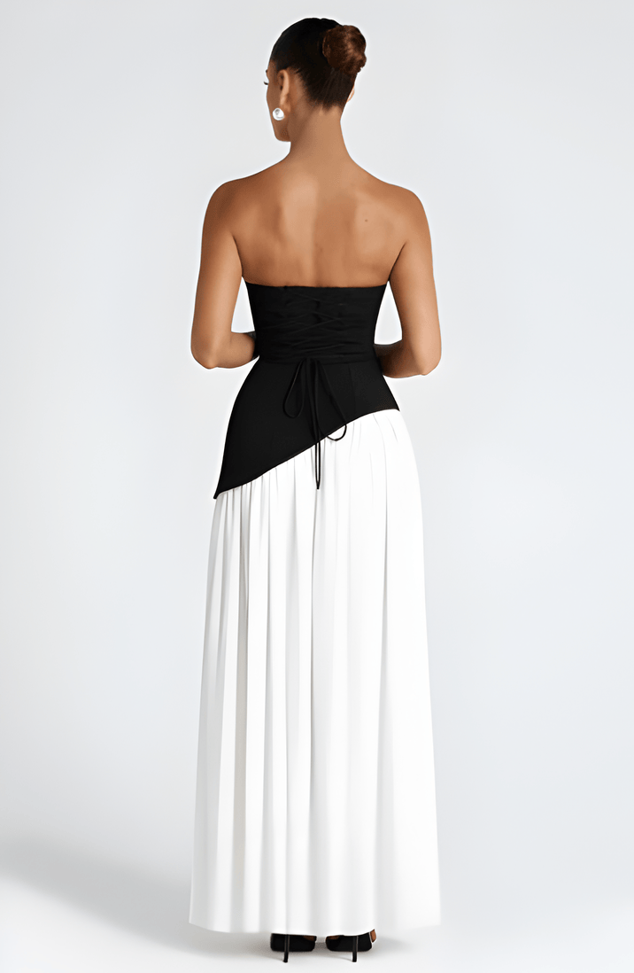 Strapless black and white maxi dress with high slit skirt and draped waist panel