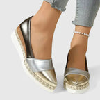Women's two-tone loafers with metallic toe, black heel panel, and espadrille wedge