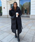 Women's long black belted puffer coat with hood and side pockets