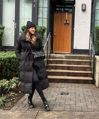 Black maxi puffer coat with hood and tie belt, long sleeves and quilted insulation