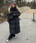 Black long puffer coat with hood and tie belt, quilted insulation and mid-ankle hem