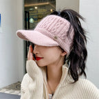Pink knitted baseball cap with ribbed brim, cable-knit crown, and small M logo badge