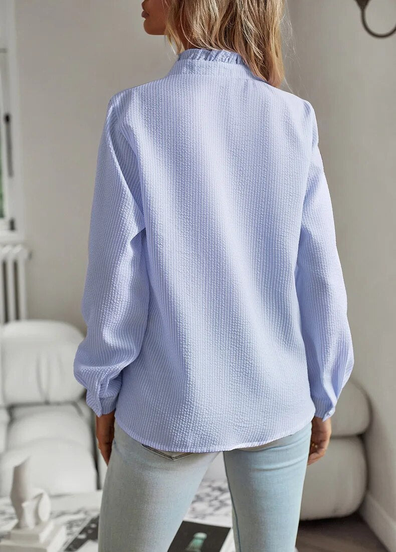 Blue long-sleeve ruffle button-up blouse, back view with button placket