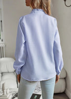 Blue long-sleeve ruffle button-up blouse, back view with button placket