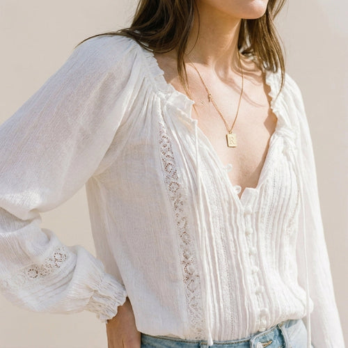 White relaxed V-neck blouse with pintuck pleats, lace trim and button front