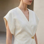 Light wrap-front blouse with V-neck and short sleeves, defined waist detail