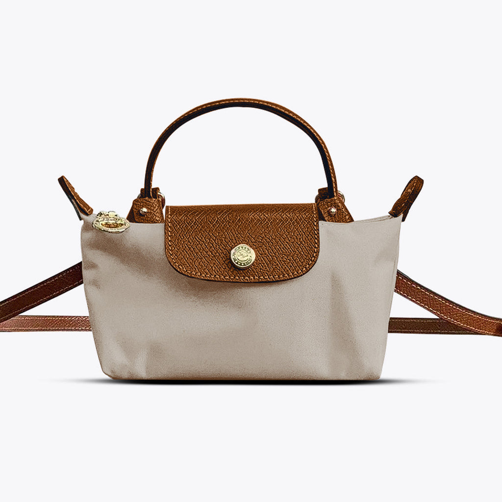 Mini crossbody shoulder bag in beige with tan flap and gold-tone front clasp, crossbody strap