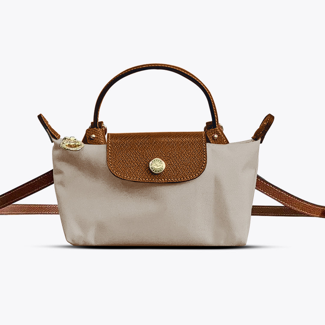 Mini crossbody shoulder bag in beige with tan flap and gold-tone front clasp, crossbody strap
