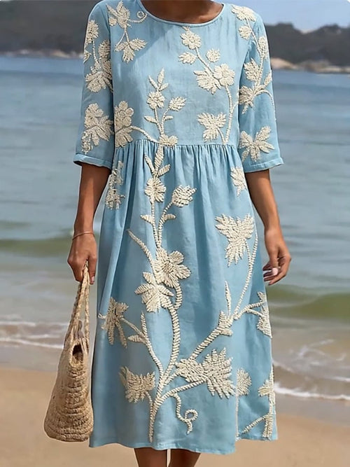Blue floral midi dress with round neck, elbow sleeves, embroidered botanical pattern, gathered waist