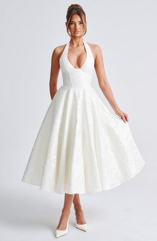 White sleeveless A-line midi dress with V-neck and gathered skirt.