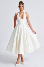 White sleeveless A-line midi dress with V-neck and gathered skirt.