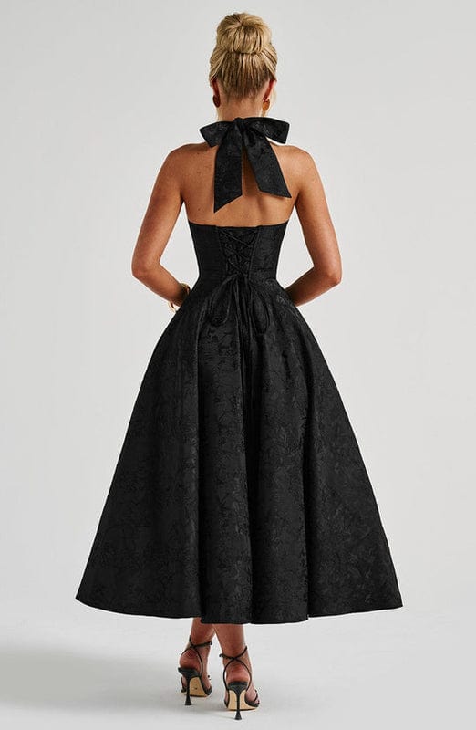 Black sleeveless A-line midi dress, open back with bow detail at top.