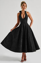 Black sleeveless A-line midi dress with V-neck bodice and full skirt.