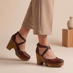 Red-burgundy closed-toe platform wedge sandals with ankle strap and crisscross upper