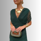Deep green off-shoulder maxi dress with draped V neckline and pleated skirt
