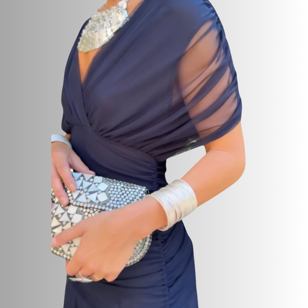 Navy off-shoulder maxi dress with draped neckline and sheer sleeve detail