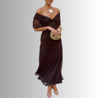 Burgundy off-shoulder maxi dress with twisted neckline and pleated, flowy skirt