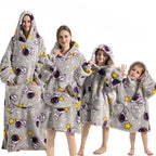 Light gray hoodie blanket with cartoon space pattern and front pocket hood