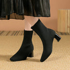 Black knit ankle boots with stretch sock fit and block heel, pointed toe