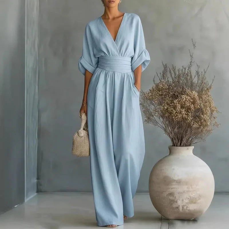 Light blue V-neck summer jumpsuit with short sleeves, cinched waist, and wide legs