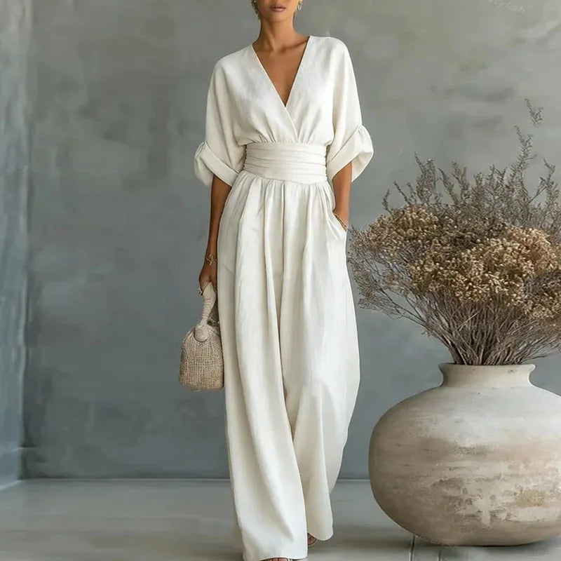 White V-neck summer jumpsuit with short sleeves, cinched waist, and wide legs