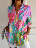 Women's abstract print blouse with button front, pink blue green swirls, long sleeves.