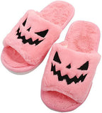 Women's pink plush Halloween jack-o-lantern slide slippers with black stitched face
