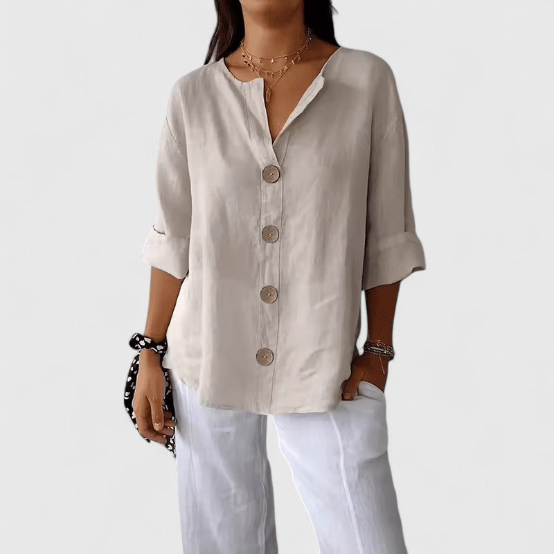 Light neutral V-neck button-front blouse with short sleeves and wooden button placket