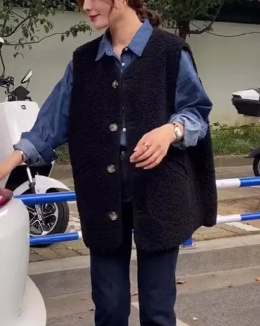 Wool gilet with button-front, black sherpa fleece texture worn over blue shirt