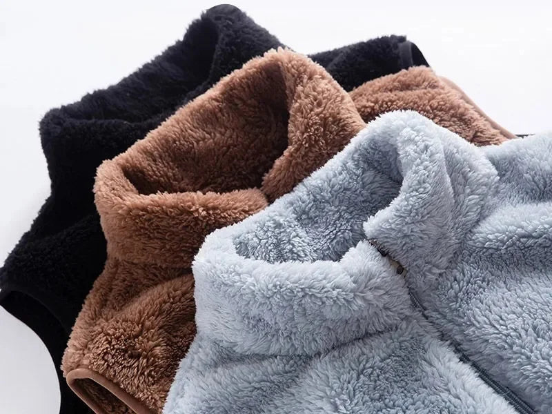 Stacked sherpa sleeveless bodywarmers in dark, camel, and light blue colors