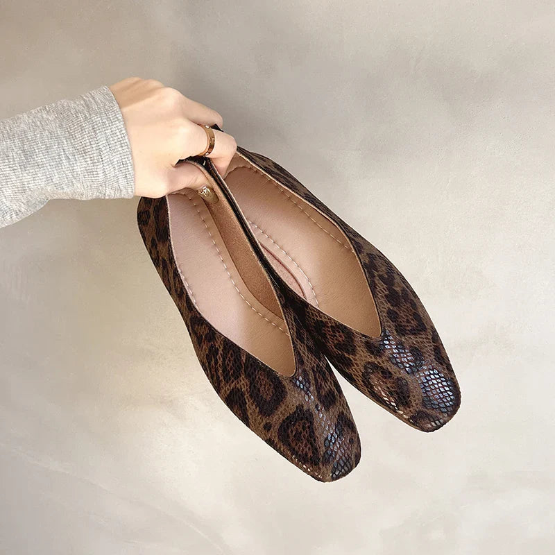Leopard print slip-on loafers in hand, glossy toe and stitched seam detailing