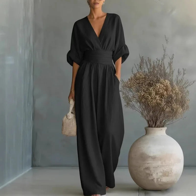 Black V-neck summer jumpsuit with short sleeves, cinched waist, and wide legs