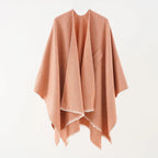 Peach cashmere poncho with V-neck, draped sleeves, fringe hem