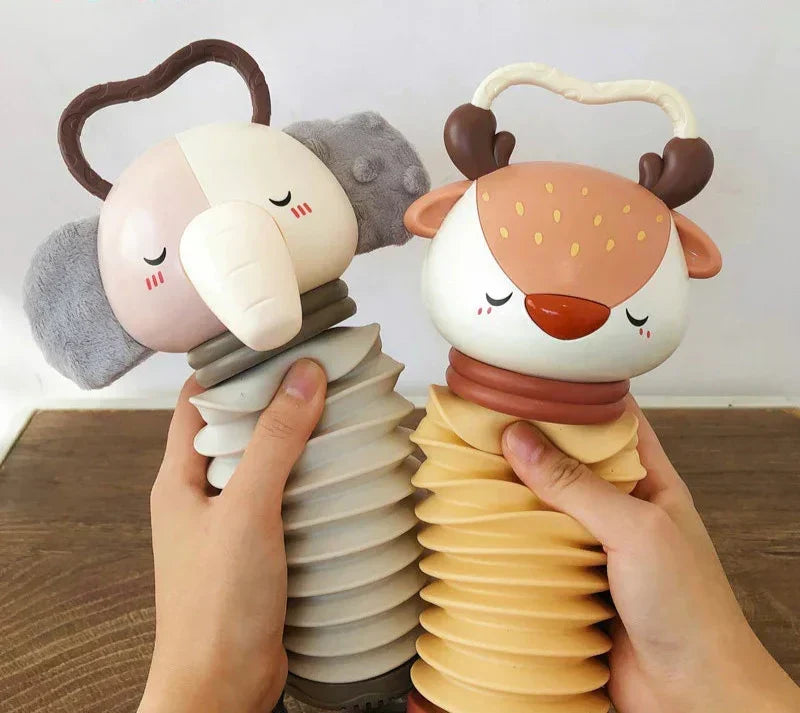 Grey and white animal accordion toy with handle, plush ears, and rattle base