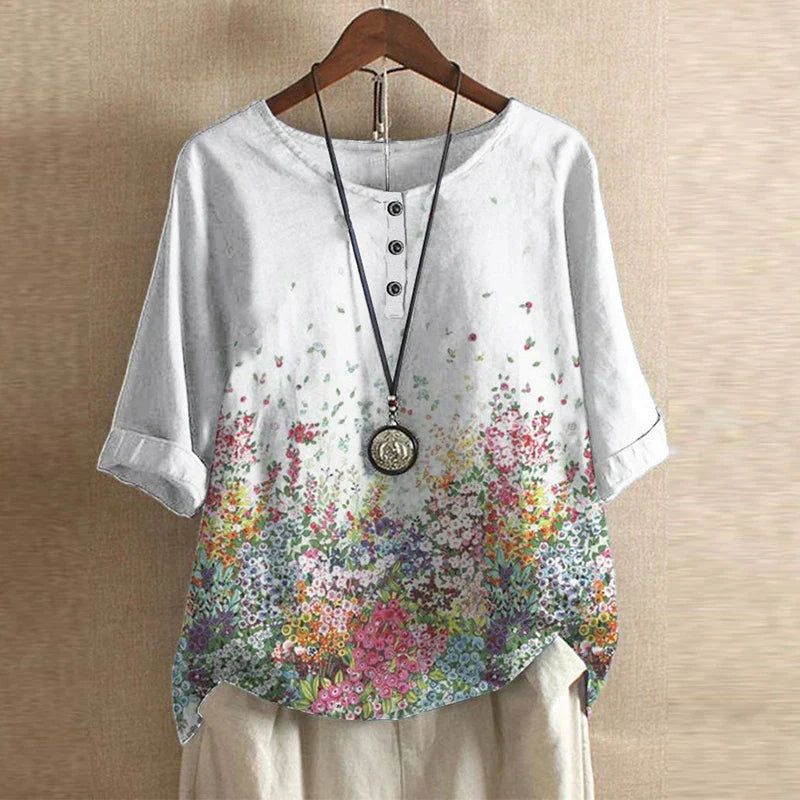 Women’s blouse in white with small red and pink floral print, short sleeves, button front