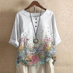Women’s blouse in white with small red and pink floral print, short sleeves, button front