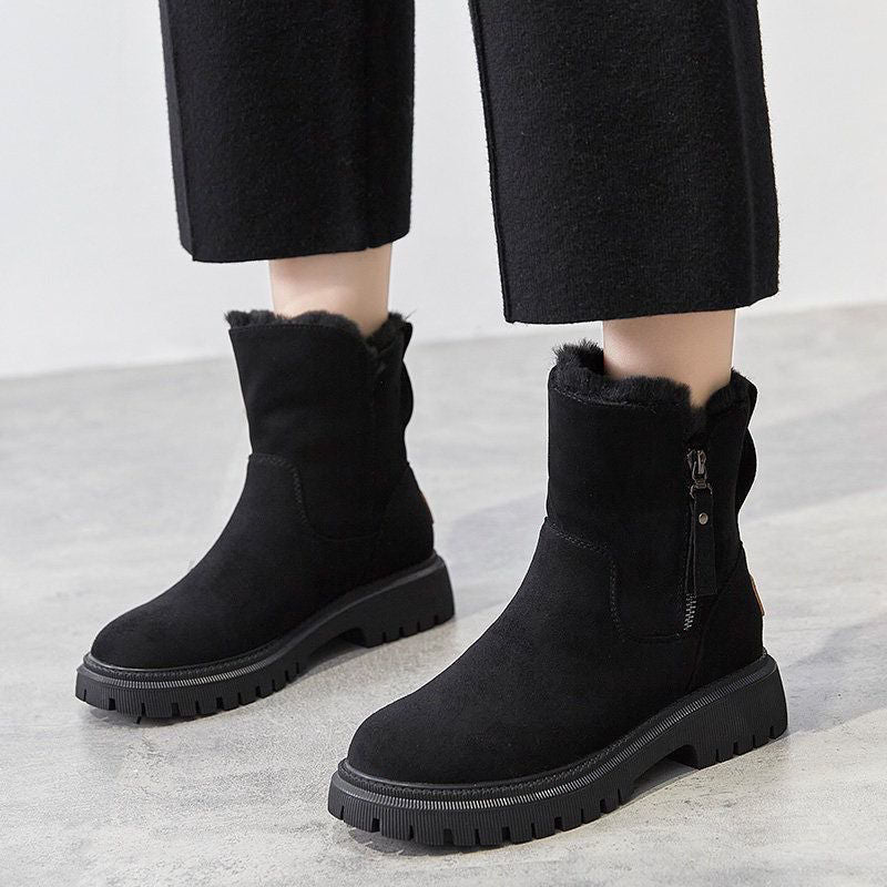 Black women’s ankle boots with round toe, side zipper, and rugged lug tread sole