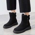 Black women’s ankle boots with round toe, side zipper, and rugged lug tread sole
