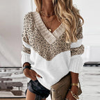 Leopard-print V-neck sweater with white body and ribbed cuffs, long sleeves