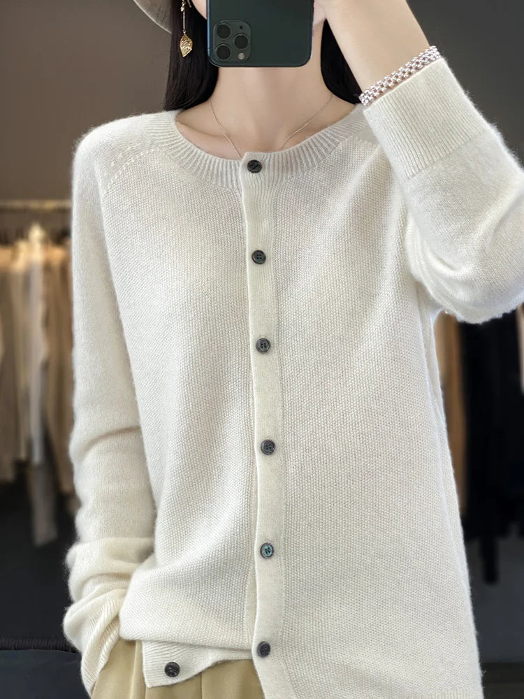 Women’s cardigan sweater, button-front knit, long sleeves, white knit with buttons.