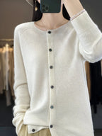 Women’s cardigan sweater, button-front knit, long sleeves, white knit with buttons.