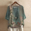 Women’s blouse in teal green with vintage floral print, short sleeves, button front