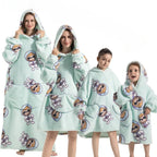 Light blue hoodie blanket with cartoon character pattern and front pocket hood
