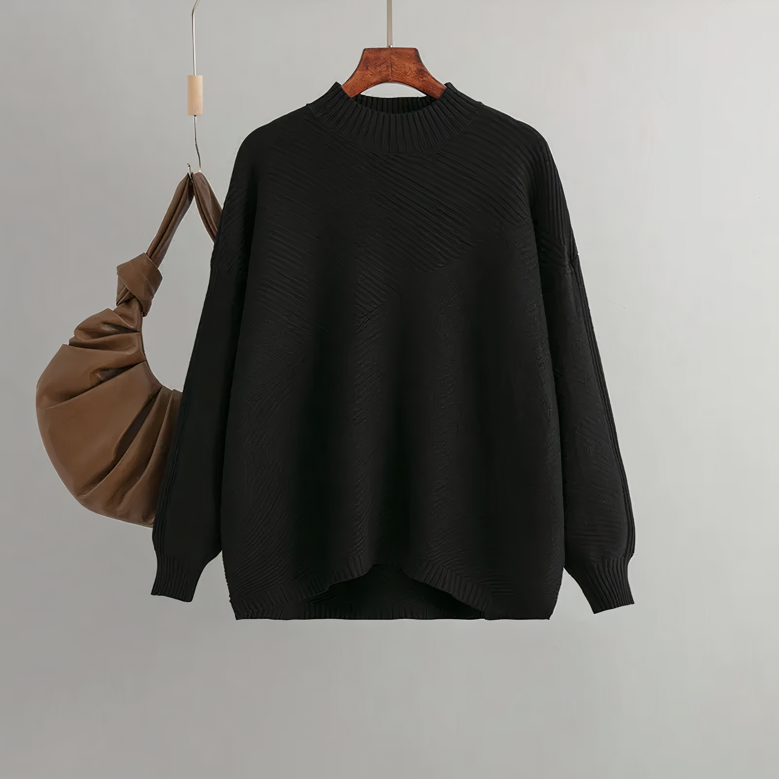 Black knit women's sweater with crew neck, ribbed cuffs and hem, relaxed fit